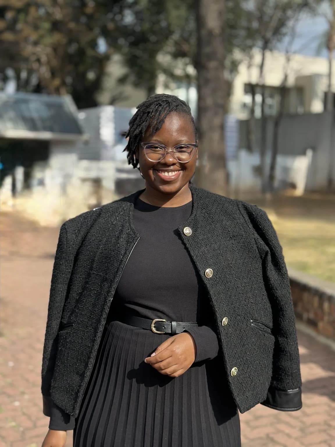 Nqobile Mnisi in a black professional outfit outdoors
