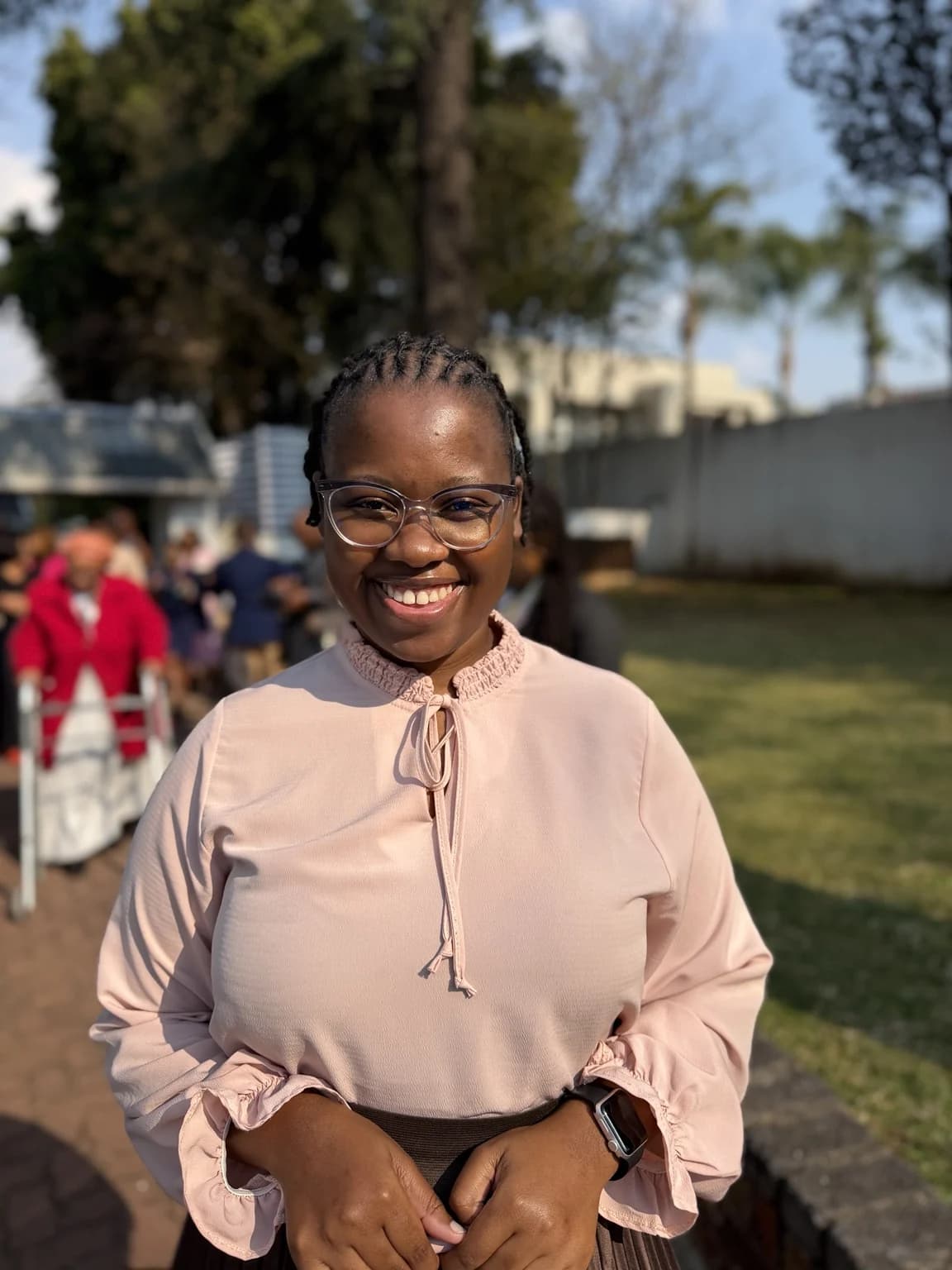 Nqobile Mnisi in a pink blouse outdoors